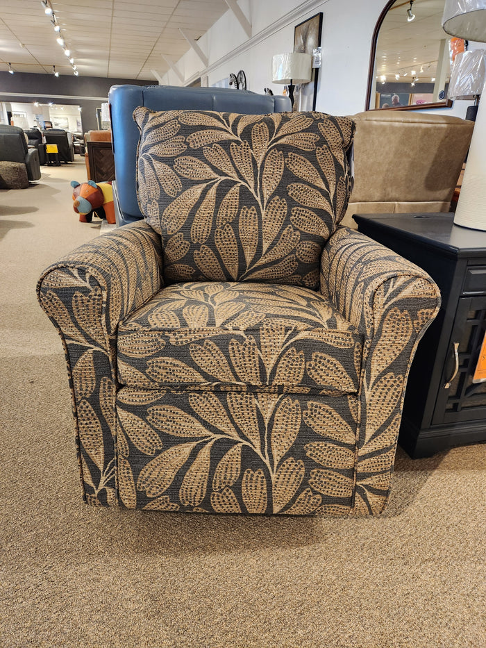 The Best Kacey Swivel Glider Chair features tan and brown leaf upholstery and a reversible seat cushion.