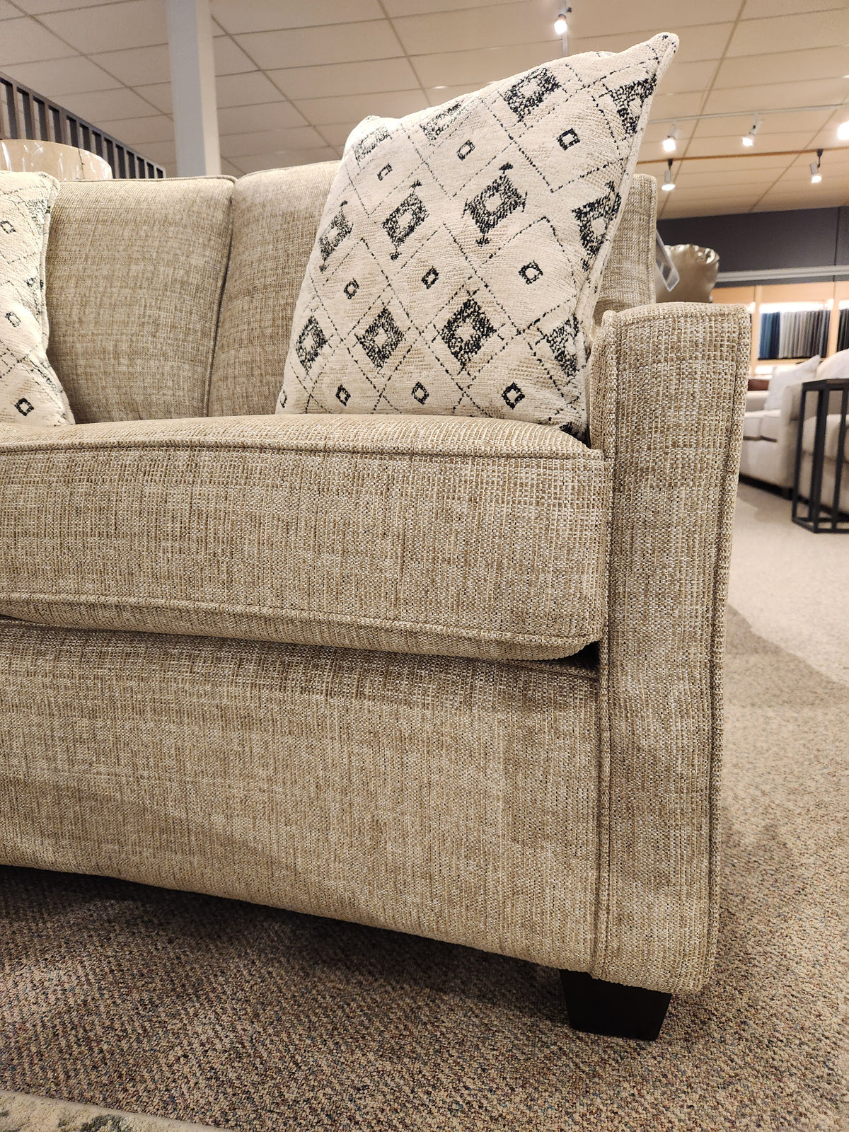 Superstyle 9670 Loveseat with medium-firm seating and patterned pillows shown in a beige finish in a showroom.