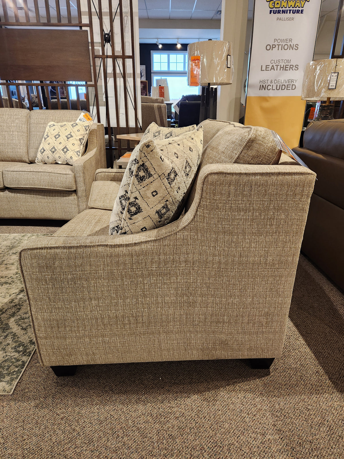 Superstyle 9670 Loveseat with patterned pillows and medium-firm seating on display in a Canadian showroom.