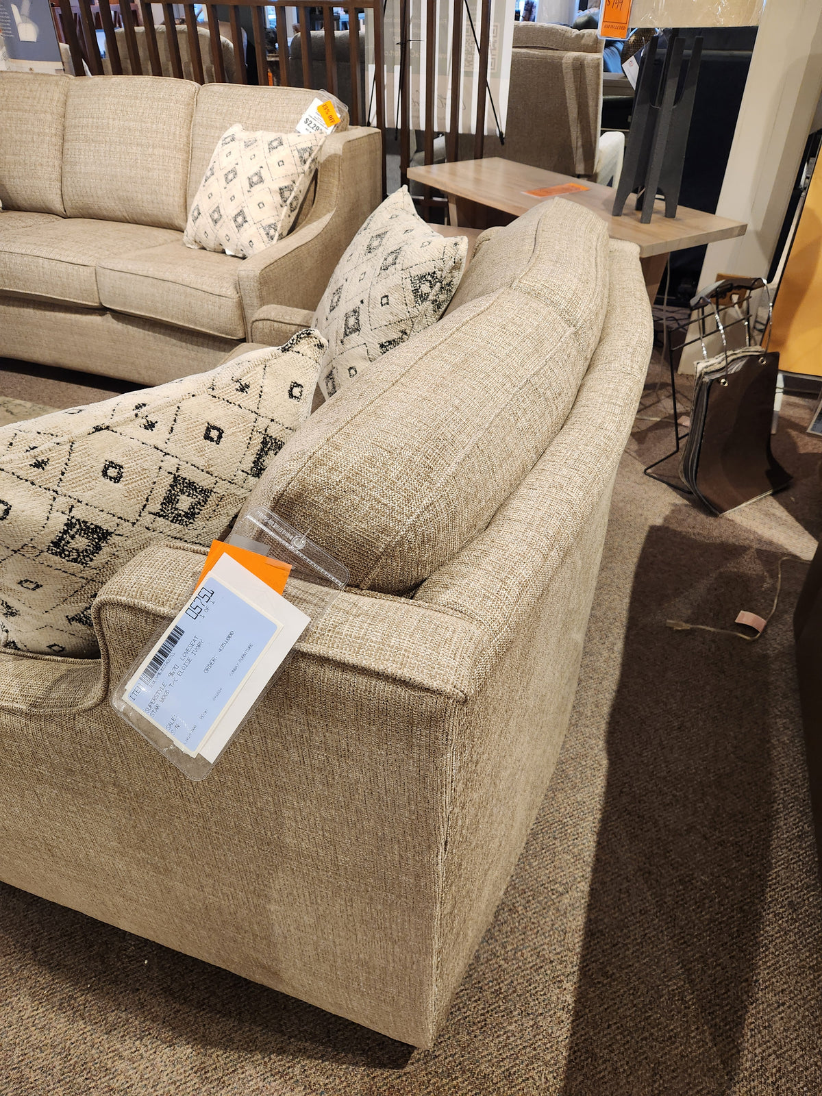 The Superstyle 9670 Loveseat, beige with patterned cushions and medium-firm seating, is on display in Canada.