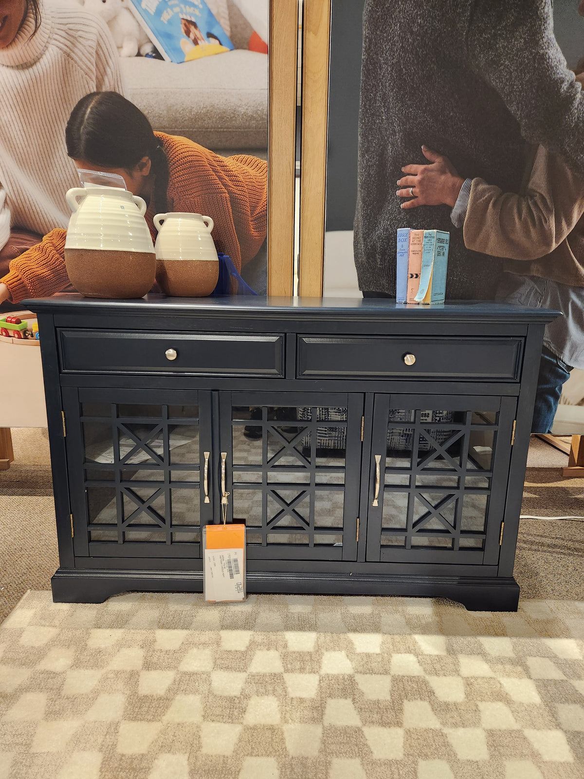 The Jofran 775 Craftsman Console is a navy media cabinet with antique hardware, two drawers, and glass-front doors.