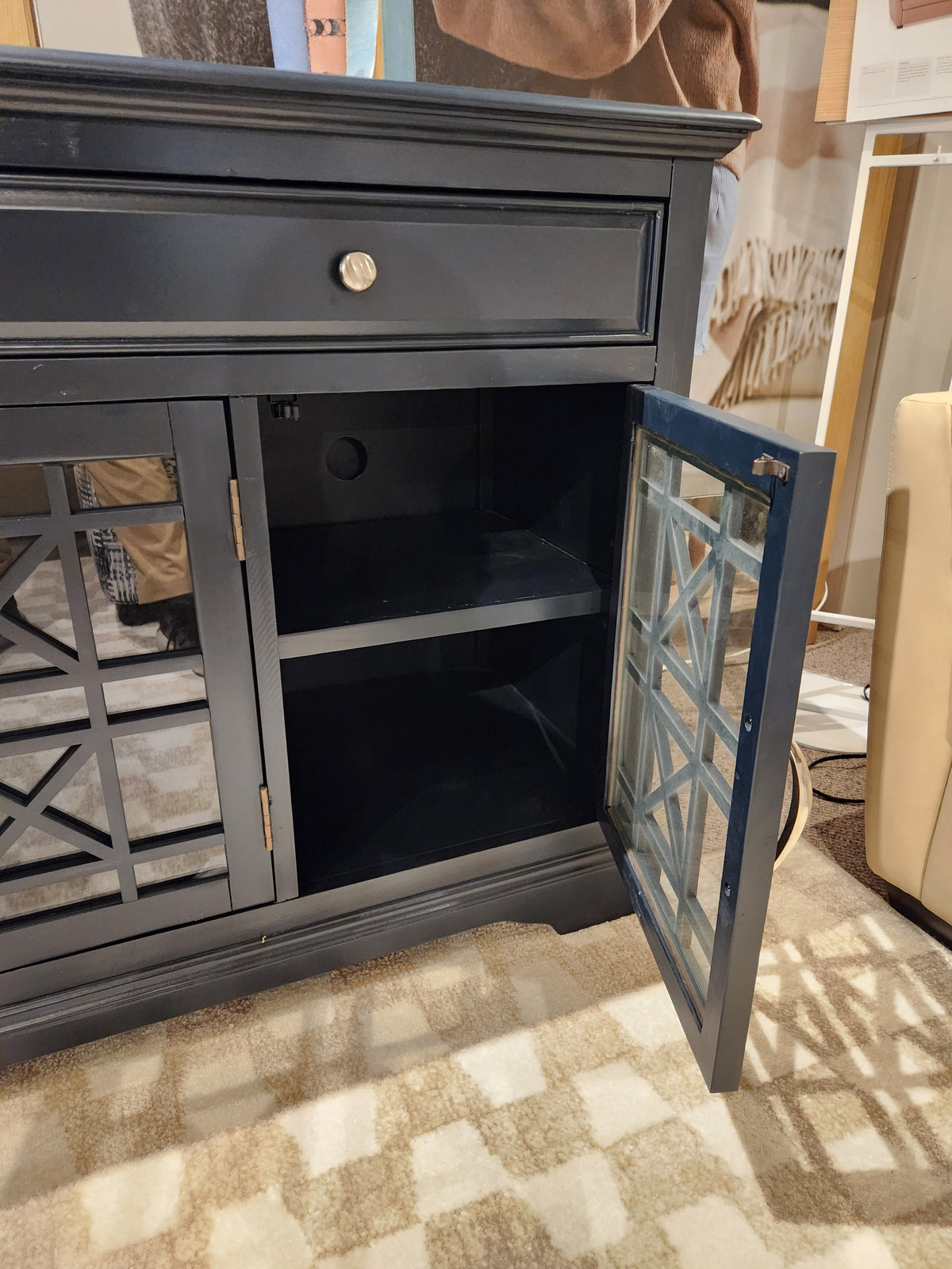 The Jofran 775 Craftsman Console features antique hardware, mirrored doors, and shelving, resting on a patterned carpet.