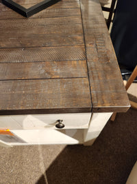Close-up of the 1706 Madison County End Table by Jofran, featuring barn door accents and a visible wood grain drawer.