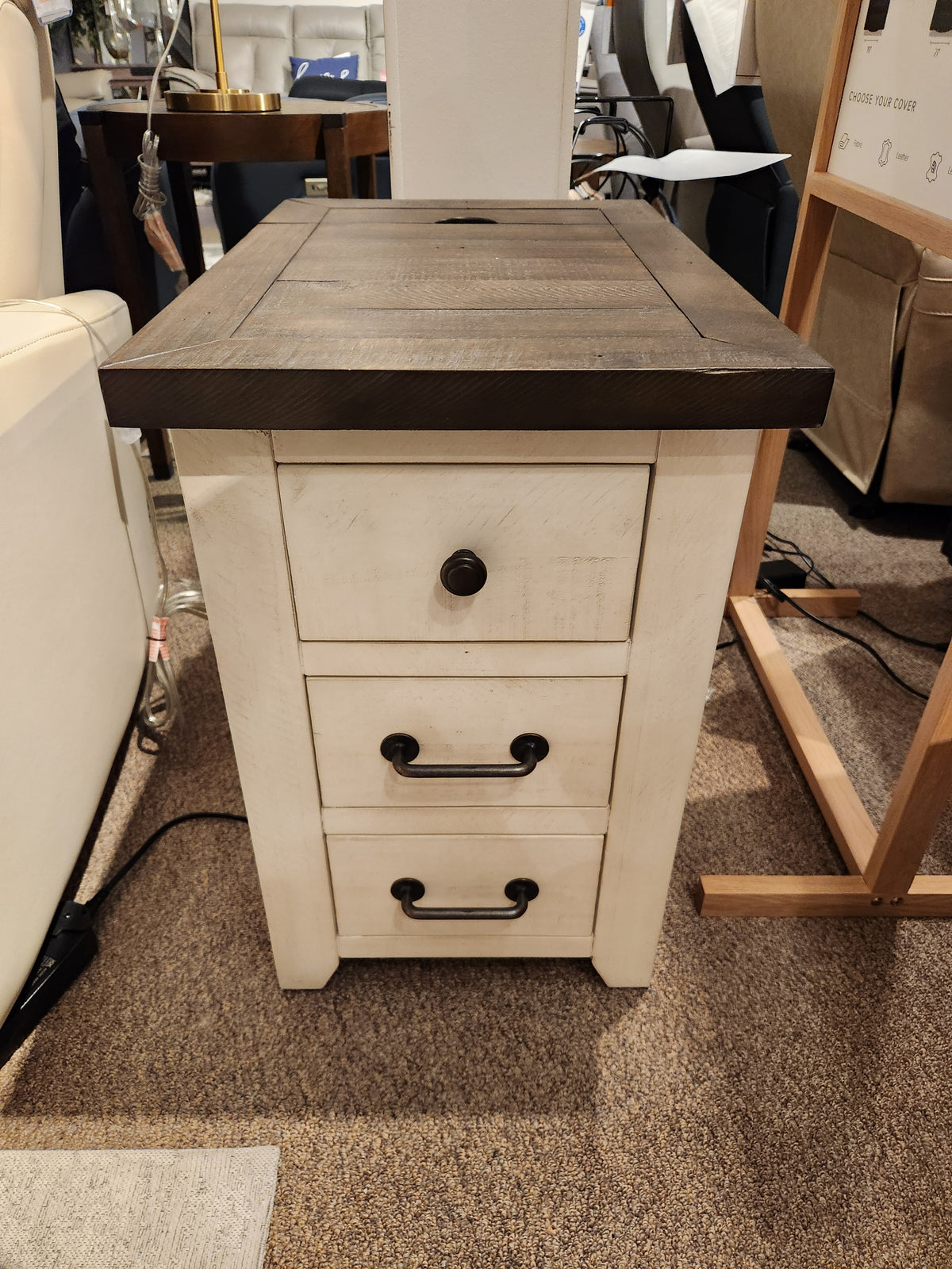The Jofran 1706 Madison County Power Chairside End Table has a dark top and three drawers, shown on carpet.