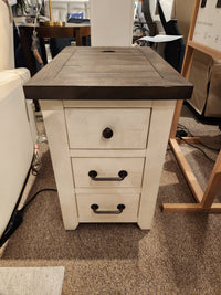 The Jofran 1706 Madison County Power Chairside End Table has a dark top and three drawers, shown on carpet.