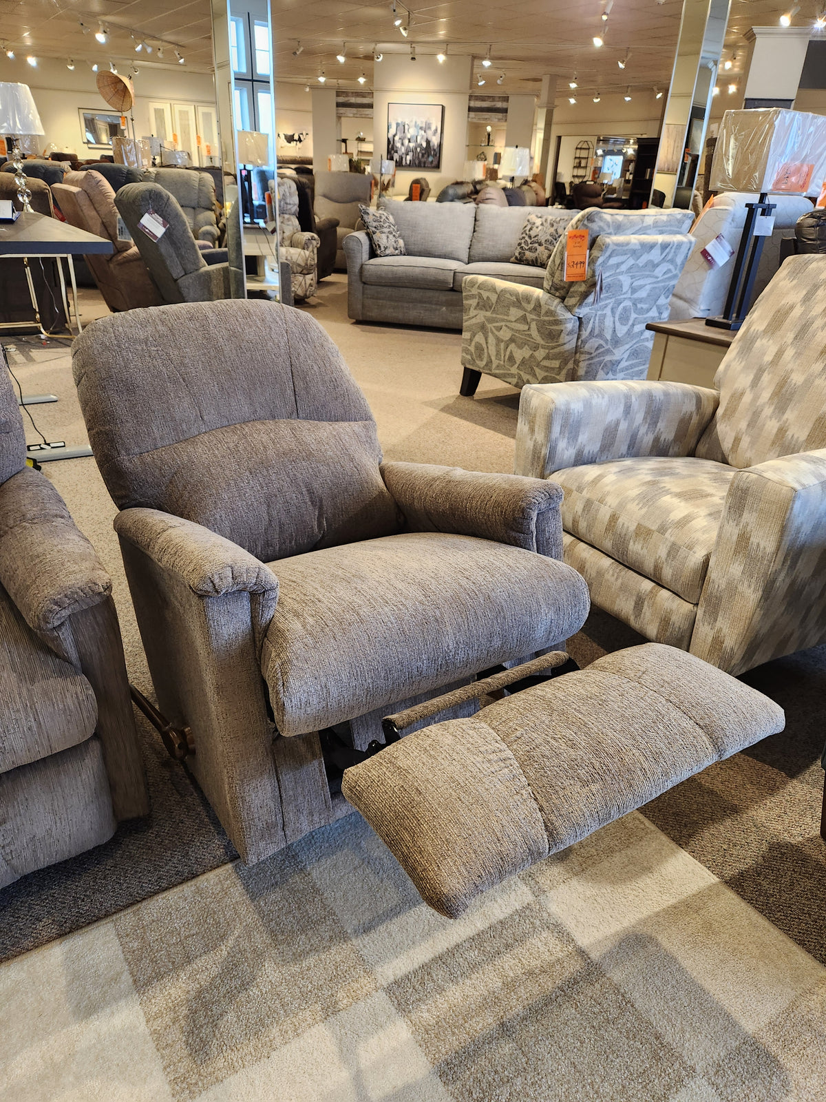The La-z-boy 795 Mercury Wall-A-Way Recliner, a brown fabric chair with extended footrest, is shown in a showroom.