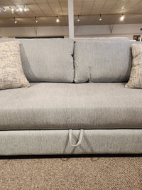 Decor-rest 2465 Queen Sofabed in gray upholstery with 2 matching pillows, shown front-facing in showroom.