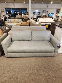 Decor-rest 2465 Queen Sofabed in light gray Canadian upholstery shown in showroom with other seating options.