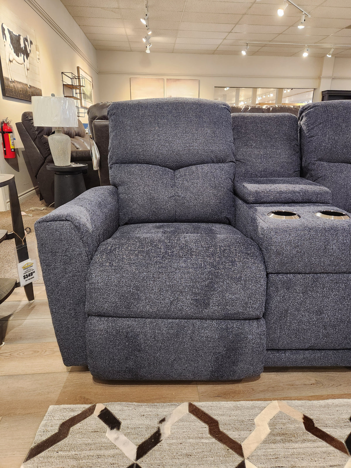 La-z-boy 780 Hawthorn Reclining Loveseat With Console, gray upholstery and cup holders, shown in a neutral showroom.