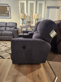 A La-z-boy 780 Hawthorn Reclining Loveseat With Console, dark blue, is displayed next to a sofa and side table.