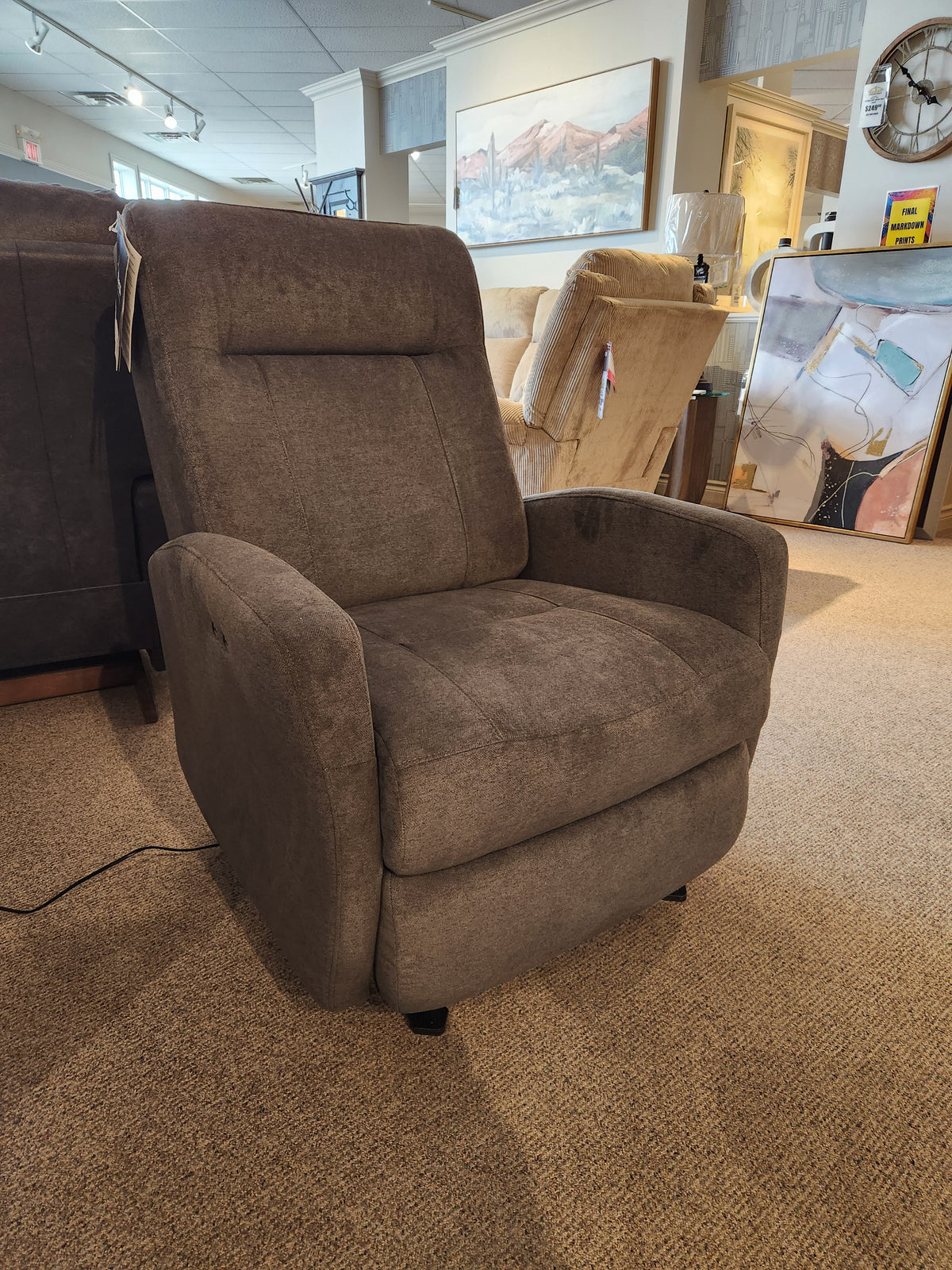 A Best 2AP34 Power Space Saver Recliner in gray is shown on carpet in a furniture showroom.