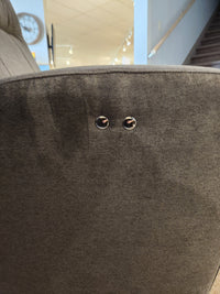 Close-up of the Best 2AP34 Power Space Saver Recliner, gray upholstery with two circular metal fasteners near the top.