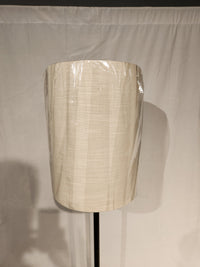 The Adesso Lamp Liam Floor Lamp features a beige plastic fabric shade on a black stand against a white background.