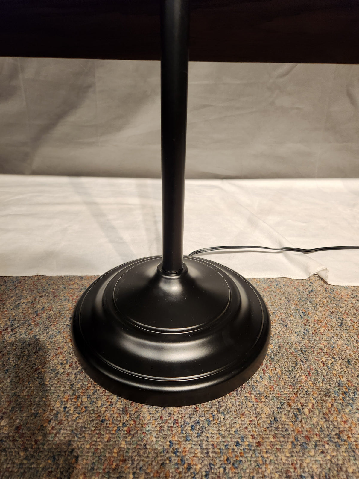 The Adesso Lamp Chandler 3 Piece Set features a black metal base on speckled carpet, power cord on the right.