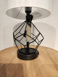 The Adesso Lamp Chiara 2 Piece Set features modern black metal lamps with geometric bases and white shades.