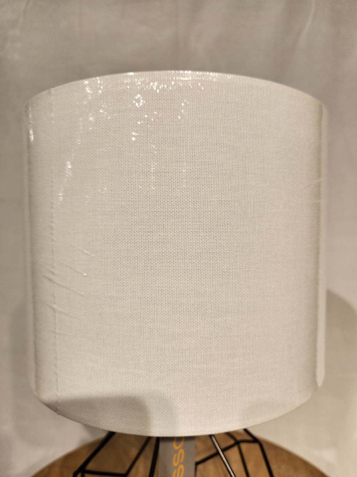 A close-up of the Chiara 2 Piece Set by Adesso Lamp, featuring white textured shades and black metal bases with AC outlets.