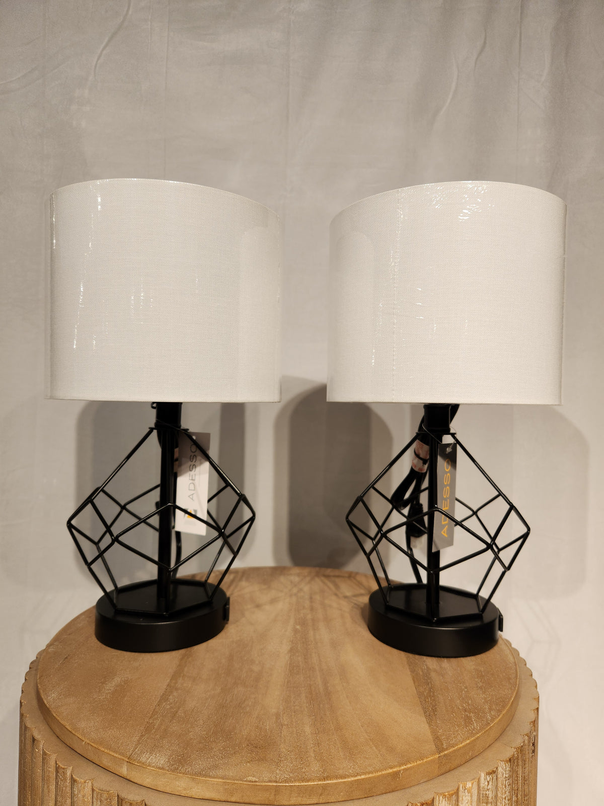 The Chiara 2 Piece Set by Adesso Lamp features modern table lamps with AC outlets and black metal bases.