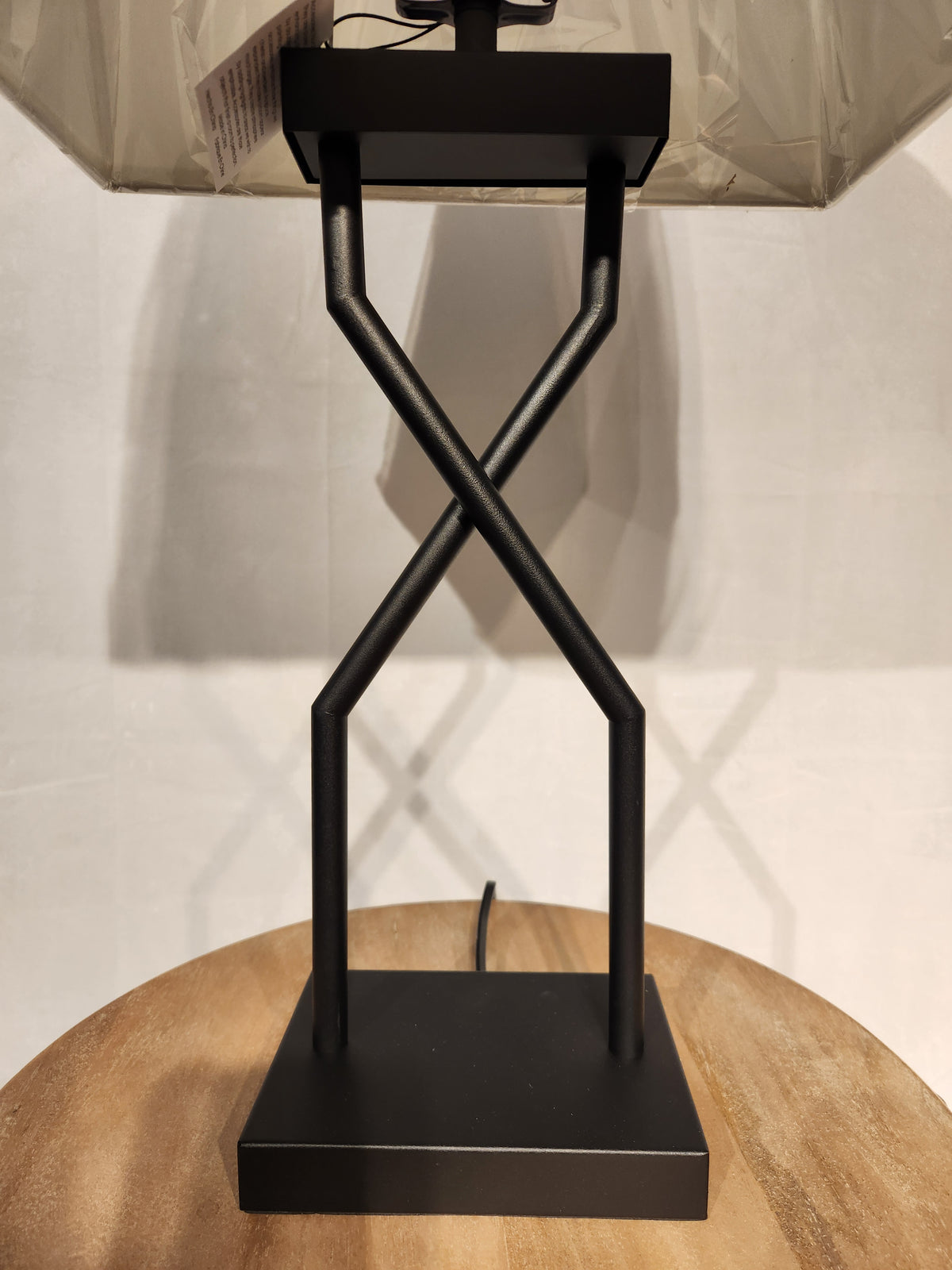The Ashley Brookthrone Metal Table Lamp features a black geometric base, adding modern style to any space.
