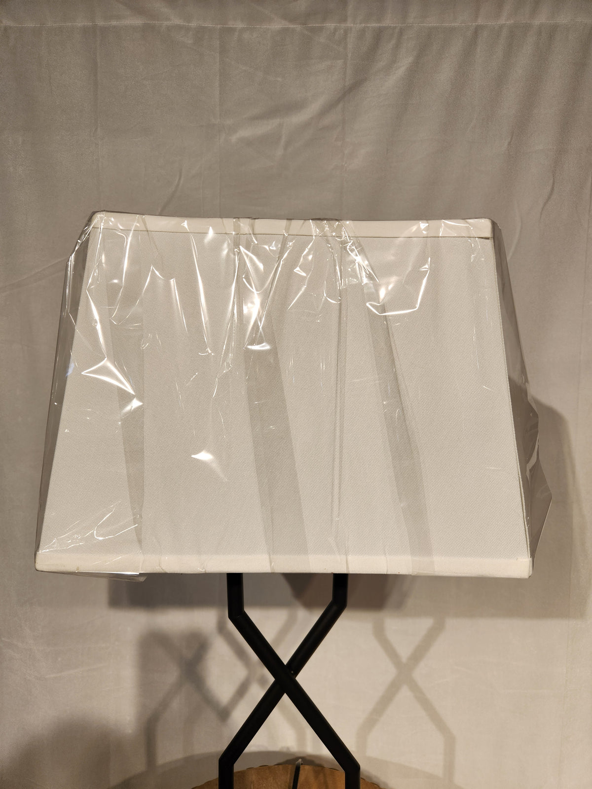 The Ashley Brookthrone Metal Table Lamp features a black base and white rectangular shade against a plain background.