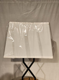 The Ashley Brookthrone Metal Table Lamp features a black base and white rectangular shade against a plain background.