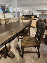 The 2491 Bellamy Dining Package by Magnussen features pine and matching chairs, shown with other wood pieces.