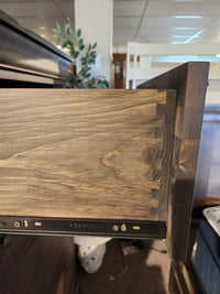 A drawer in the Vokes 262-405 Bayshore 5 Drawer Chest is open, showing dovetail joints and a metal sliding track.