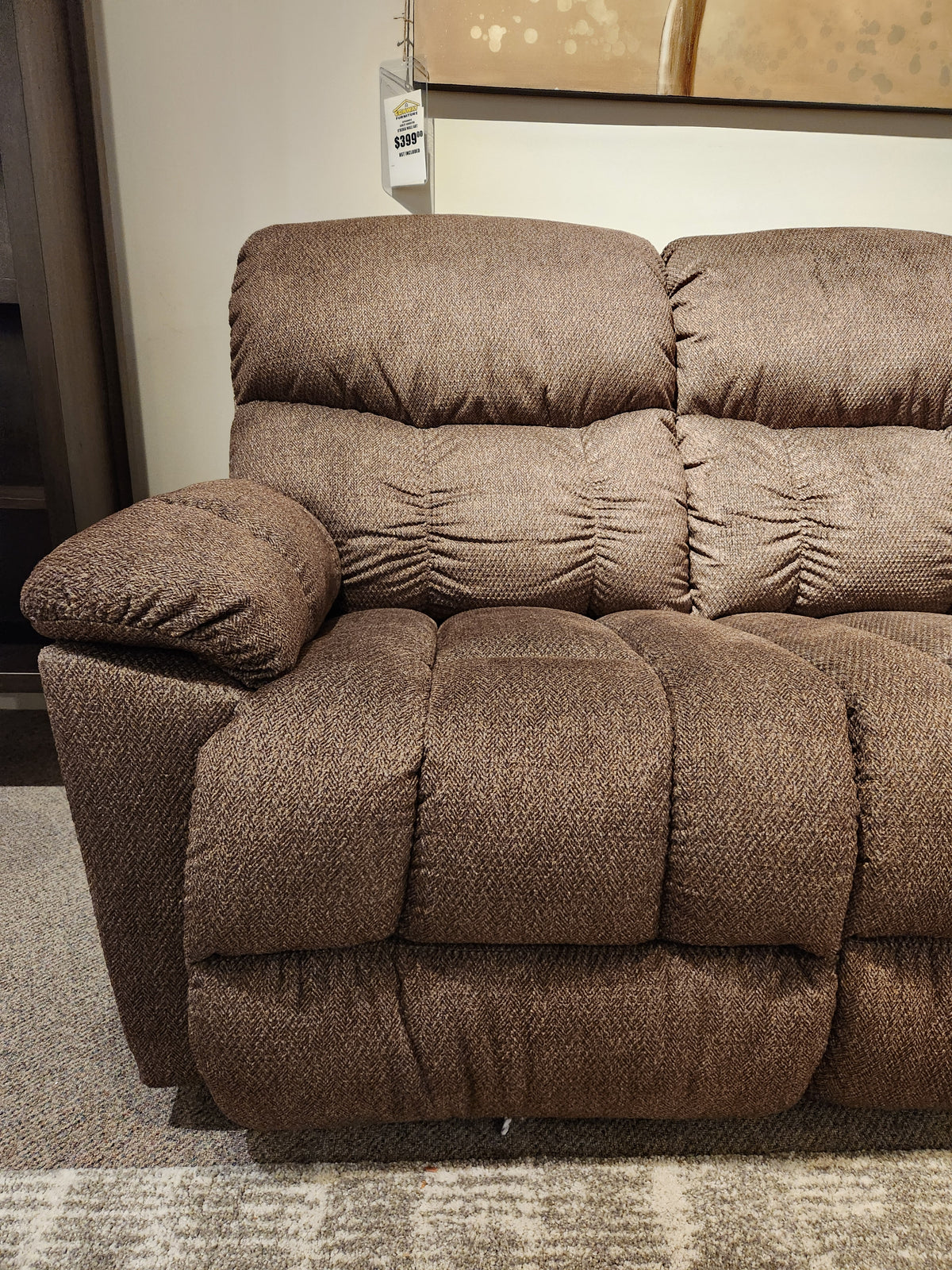 La-Z-Boy 766 Morrison Reclining Sofa with plush cushioning on carpet; price tag and wall art partially visible above.