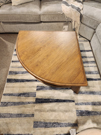 Magnussen T6354 Tanner Pie Shape Lift Top Cocktail Table on a striped rug with a gray sectional for California casual style.