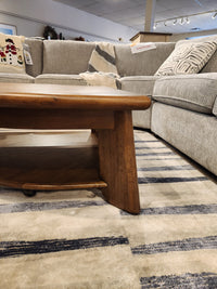 The T6354 Tanner Pie Shape Lift Top Cocktail Table by Magnussen adds style to this California Casual showroom.