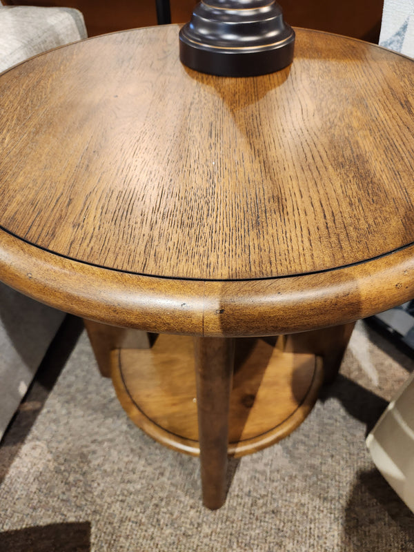 The T6354 Tanner Round End Table by Magnussen in Tawny Brown is ideal for a California Casual living space.