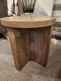 Magnussen T6348 Hayden Round End Table in Golden Oat finish, shown on carpet in a furniture store.