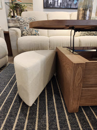 A cream cushion rests by the Magnussen T6348 Hayden Lift Top Cocktail Table, featuring a farmhouse-inspired design.