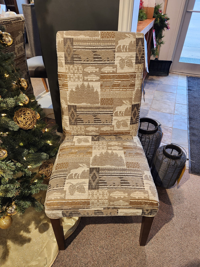 FS9800 Odell Dining Chair by Best features lodge-inspired upholstery with a nature pattern, shown beside a Christmas tree.