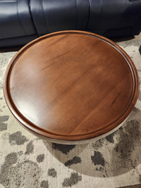 The Decor-rest 6415 Lift Top Storage Ottoman/Coffee Table sits on a patterned rug before a dark-colored sofa.