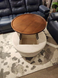 The Decor-rest 6415 Lift Top Storage Ottoman/Coffee Table offers hidden storage and sits on a patterned rug beside the sofa.