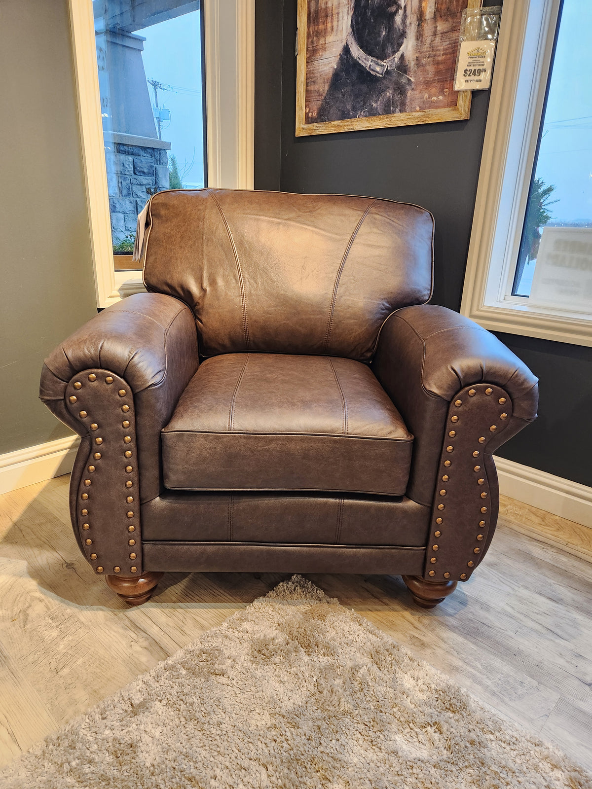 The Best Field & Stream Noble Chair, a brown leather armchair with brass studs, brings modern lodge style to any rug.