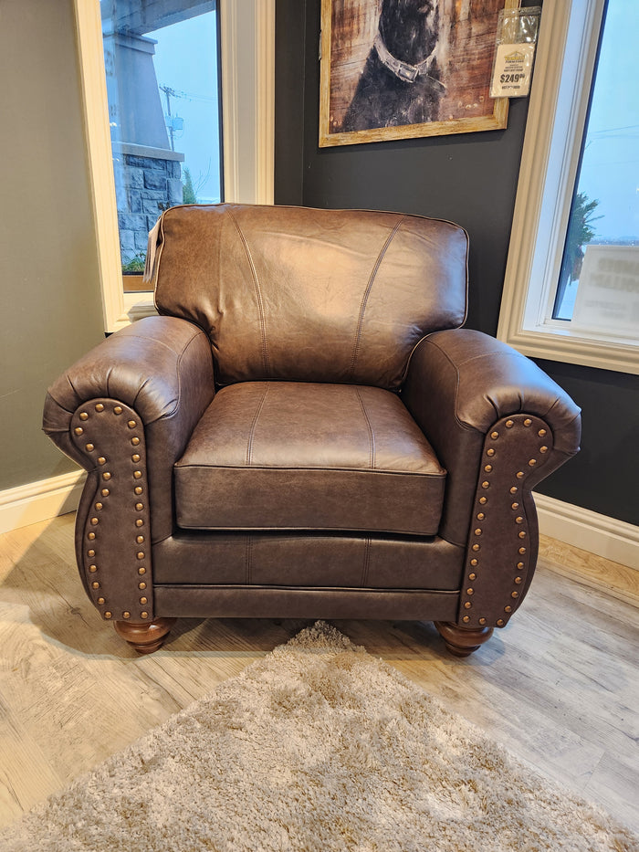 The Best Field & Stream Noble Chair, a brown leather armchair with brass studs, brings modern lodge style to any rug.