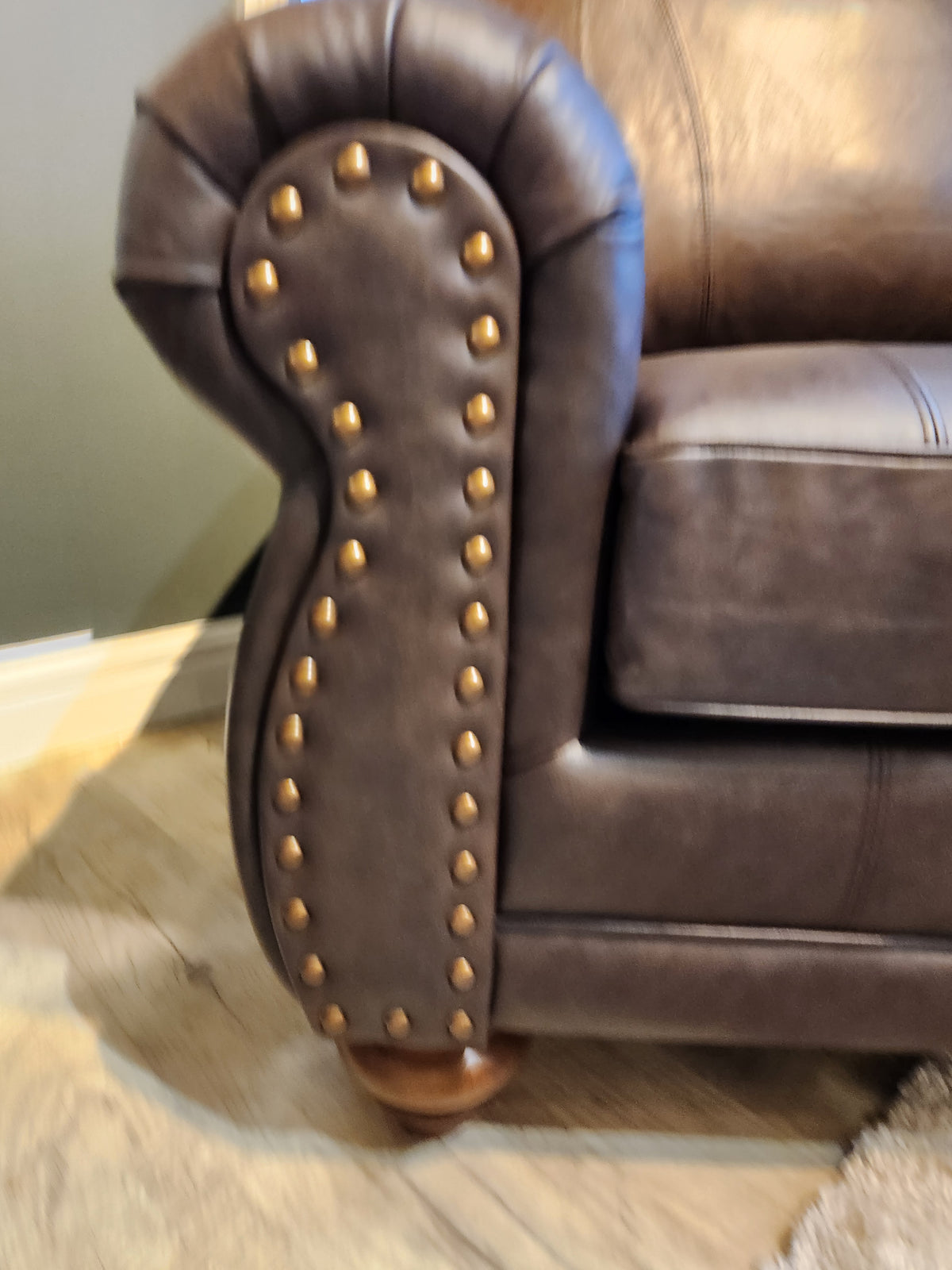 Close-up of the Best Field & Stream Noble Chair armrest with brass studs, ideal for modern lodge-style decor.