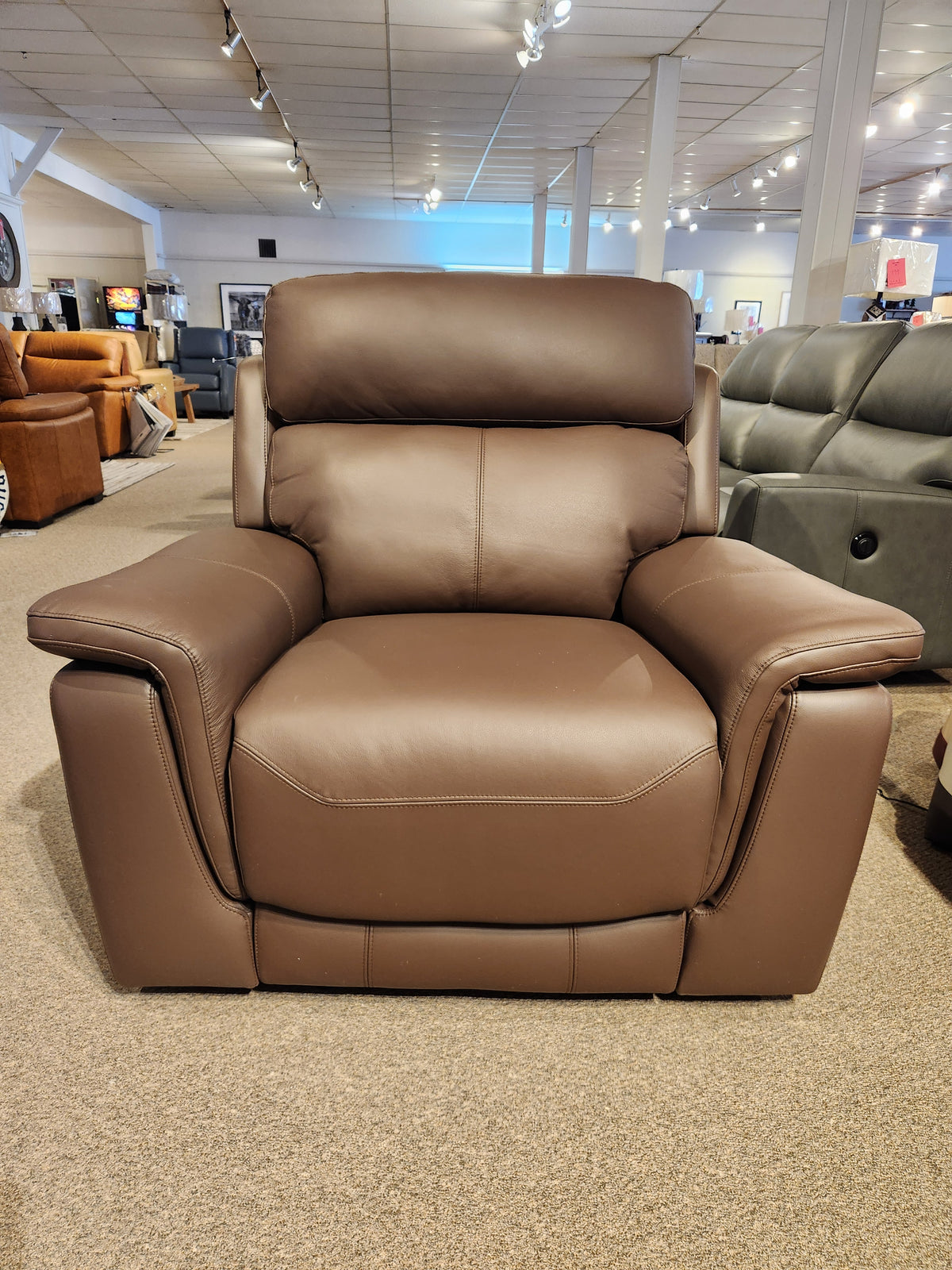 The Palliser 41051 Henry Wall-hugger Reclining Chair is showcased on a carpeted floor in a well-lit showroom.