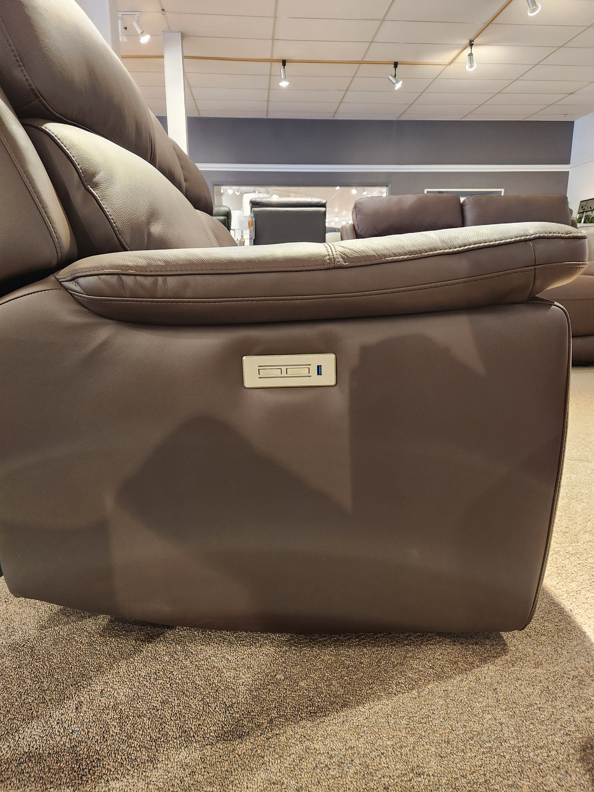 Side view of the Palliser 41051 Henry Loveseat in brown leather with power headrest and electric armrest controls.