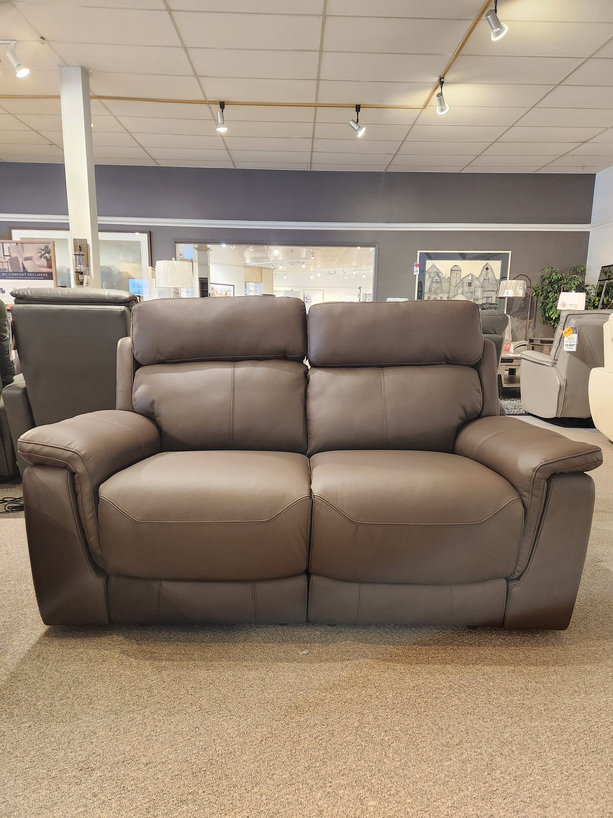 Palliser 41051 Henry Loveseat in brown leather with power headrest shown in a brightly lit showroom.