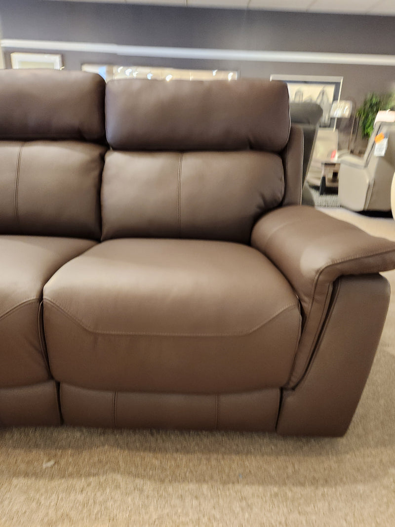 Palliser 41051 Henry Loveseat in brown leather with power headrest on display among art and other showroom furniture.
