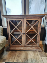 The Jofran 2028 Carrington Small Breakfront Cabinet with glass doors adds industrial edge to an Asian hardwood floor.