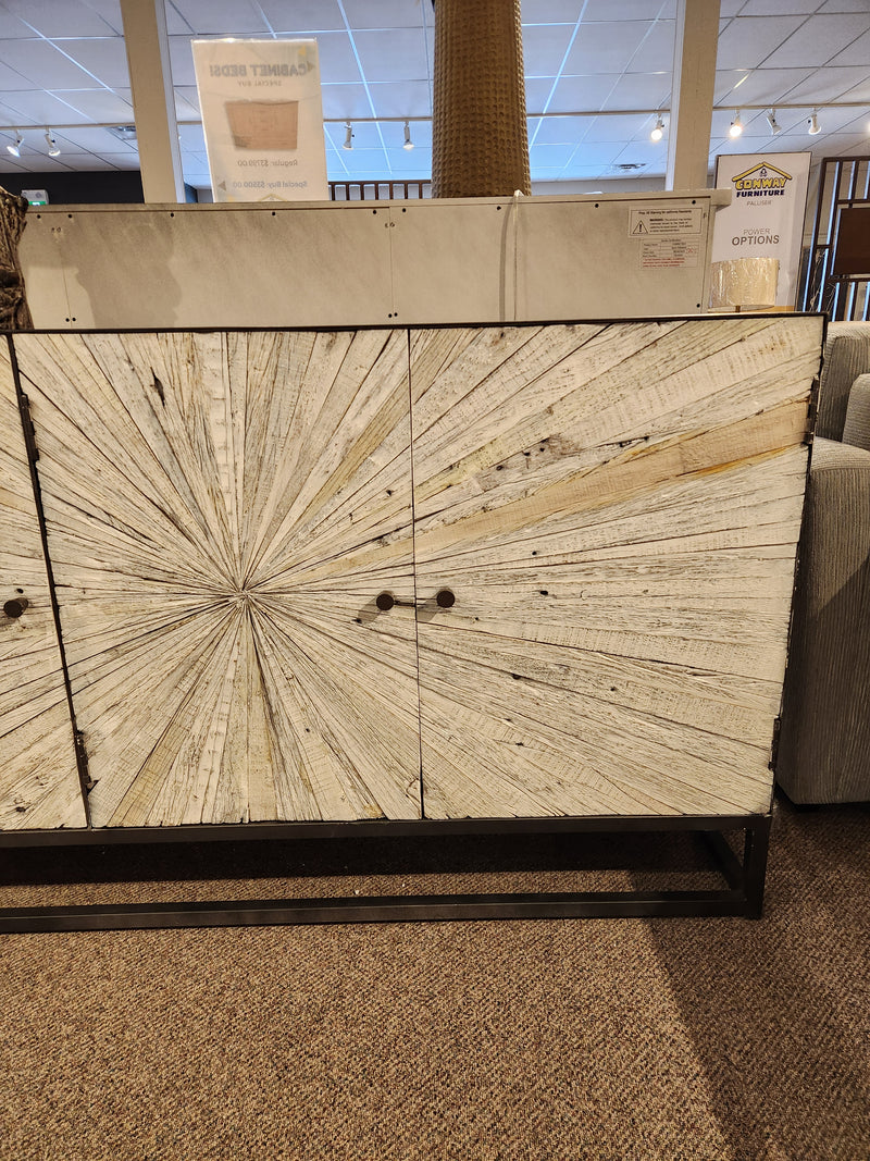 The 1929 Astral Plains 3 Door Cabinet by Jofran features textured doors with a white starburst, shown in a showroom.