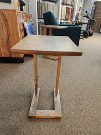 The Handstone AlaCarte Outback Snack Table is displayed on a carpeted floor in a furniture showroom.