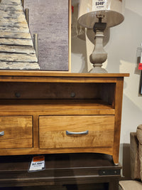 Handcrafted by Handstone, the Glengarry HDTV Cabinet pairs perfectly with a lamp and framed artwork.