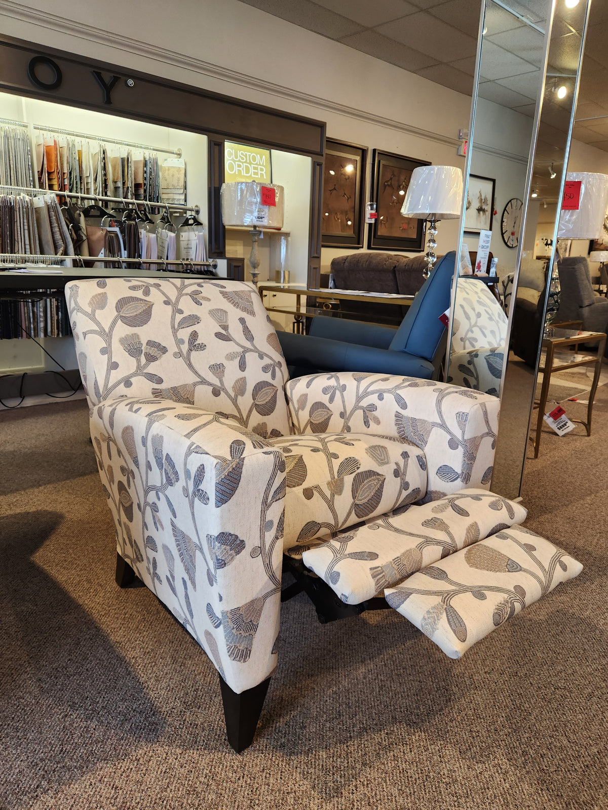 The La-z-boy 431 Scarlett High-Leg Recliner is shown with footrest extended, highlighting its sleek push-back design.