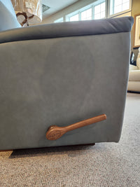 Close-up of the La-Z-Boy 820 Norton Rocker Recliner with ergonomic design and a wooden lever on a carpeted floor.