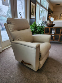 A La-Z-Boy 820 Norton Wall-A-Way Recliner in beige leather, on carpet near windows and indoor plants.