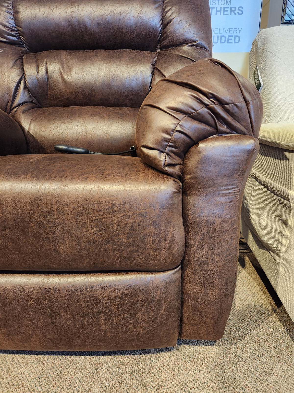 Best 1B52 Troubadour Lift Chair in brown leather with armrest remote, shown on a carpeted floor.